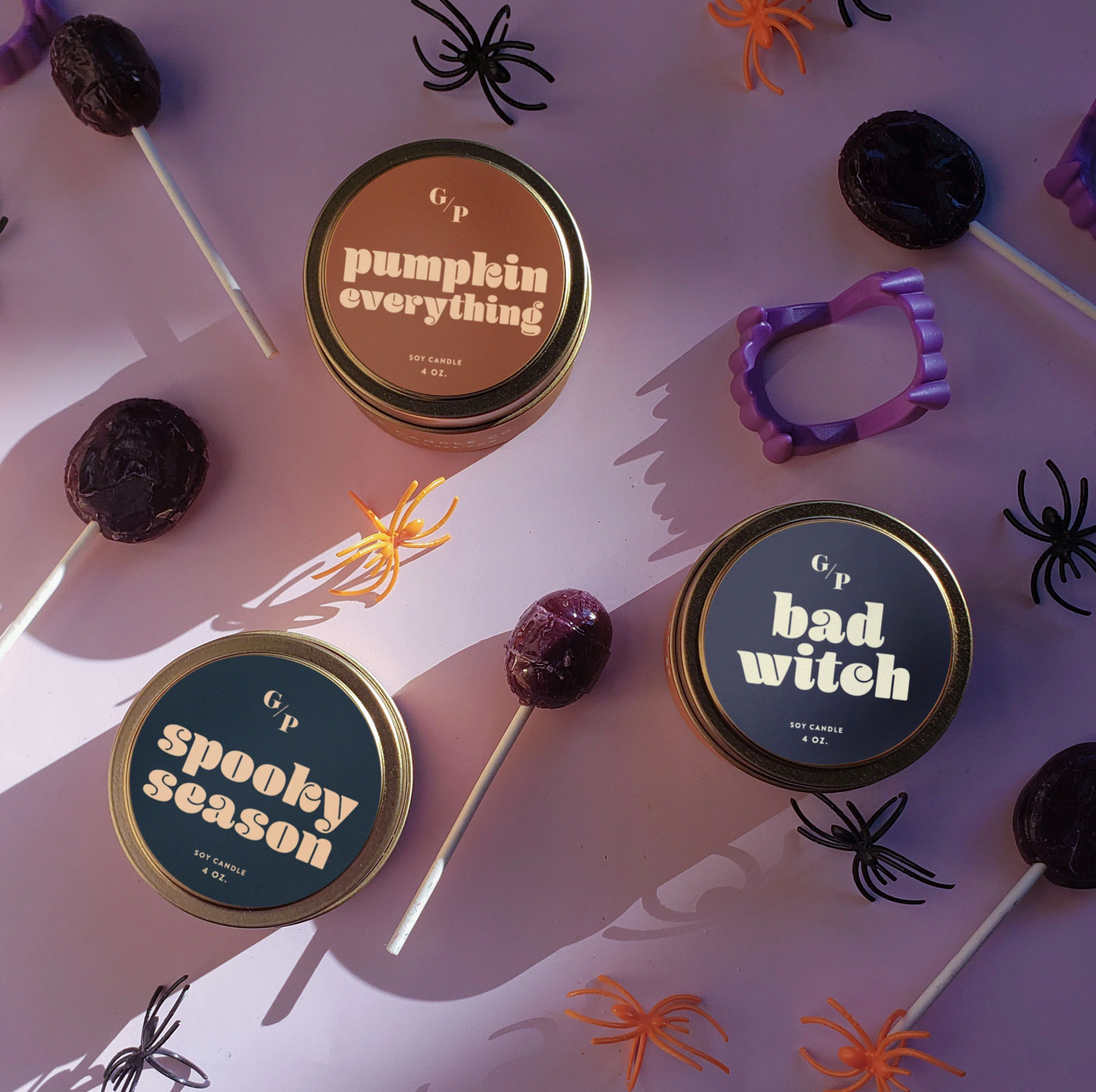 Halloween-themed candy tins with decorative elements on a white background