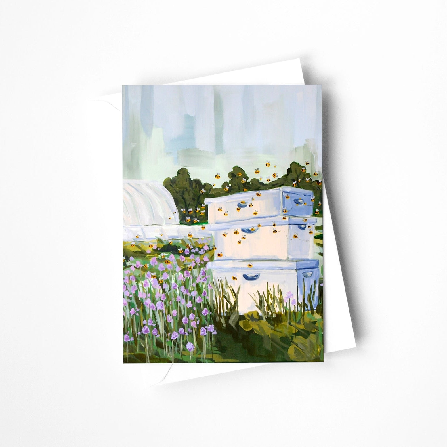 Greeting card with watercolor illustration of beehives and flowers on a white background