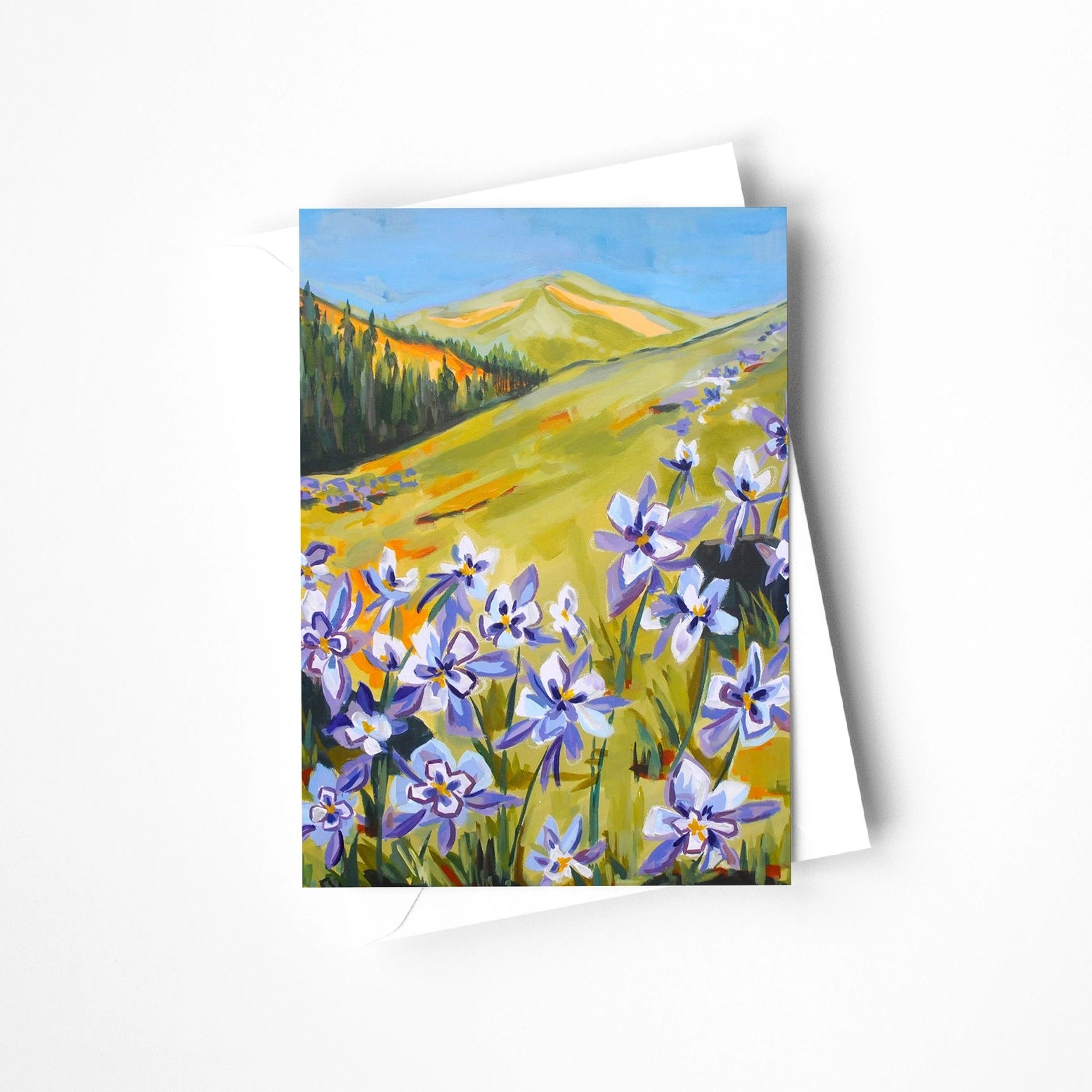 Greeting card with a painting of a mountain landscape with flowers on a white background