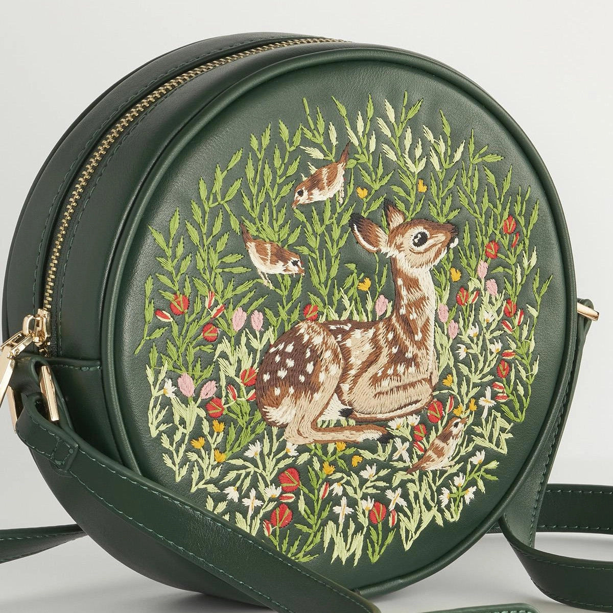 Green round bag with deer and floral embroidery on a white background