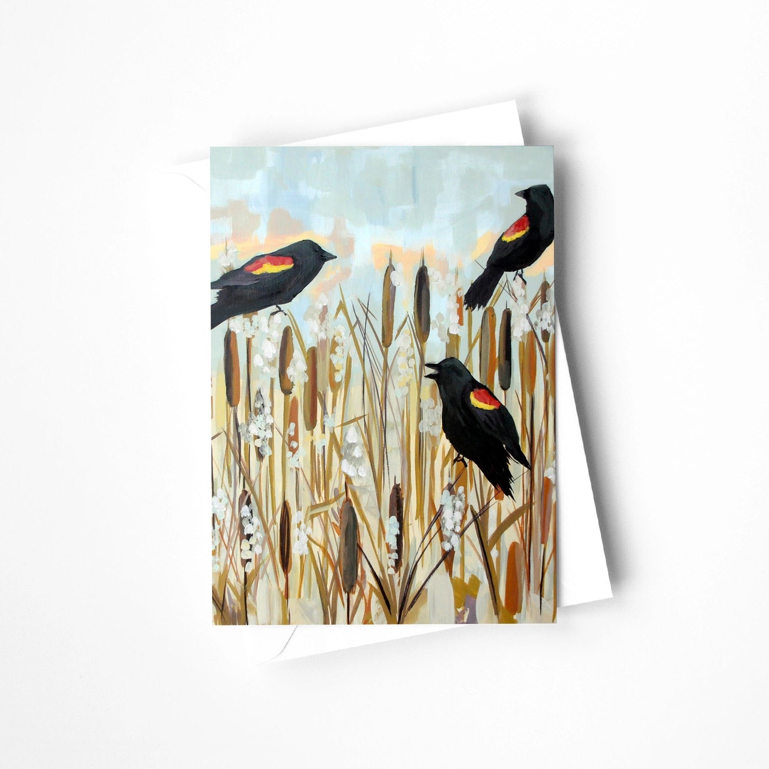 Greeting card with red-winged blackbirds and cattails on a white background